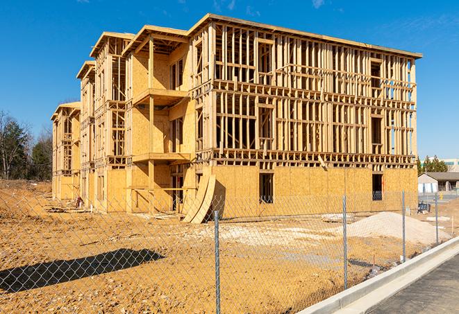 a close-up of temporary chain link fences enclosing a construction site, signaling progress in the project's development in Islip